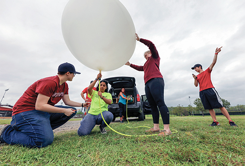 students releasing weather balloon