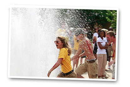 students playing in fountain