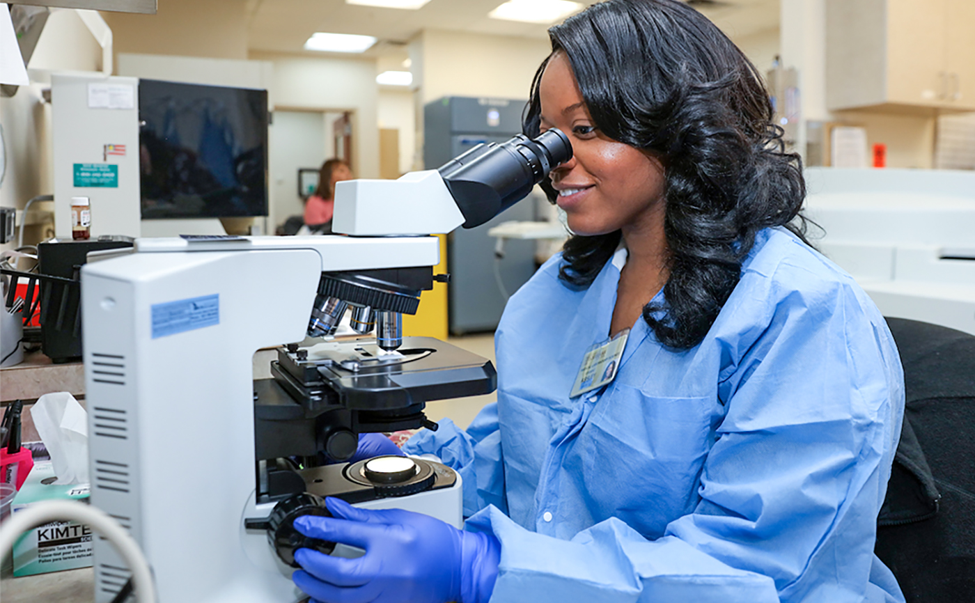 Medical Laboratory Science student using microscope