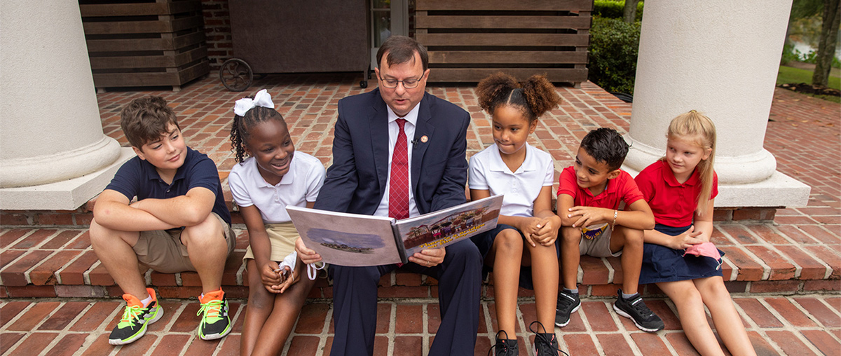 photo of President Berry reading to children