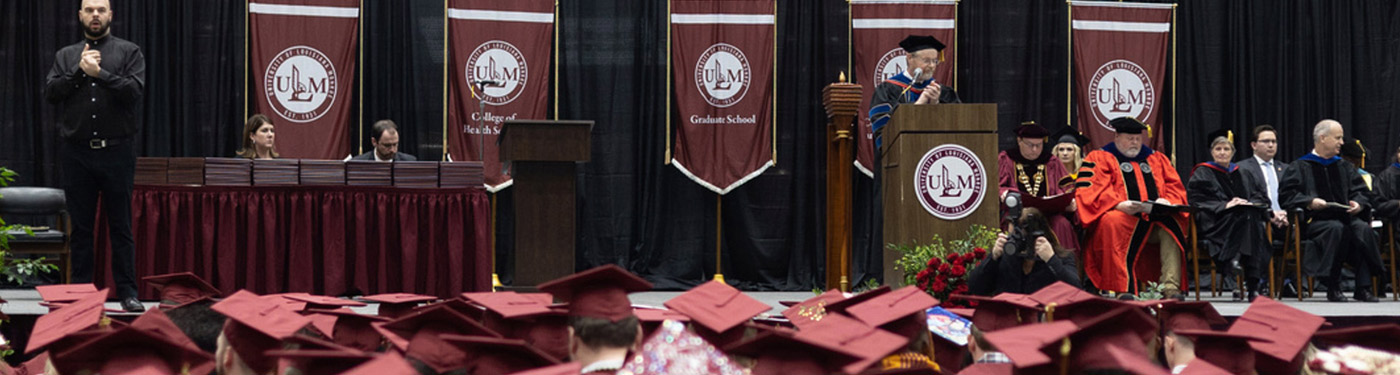commencement photo with Dr. Arant at podium