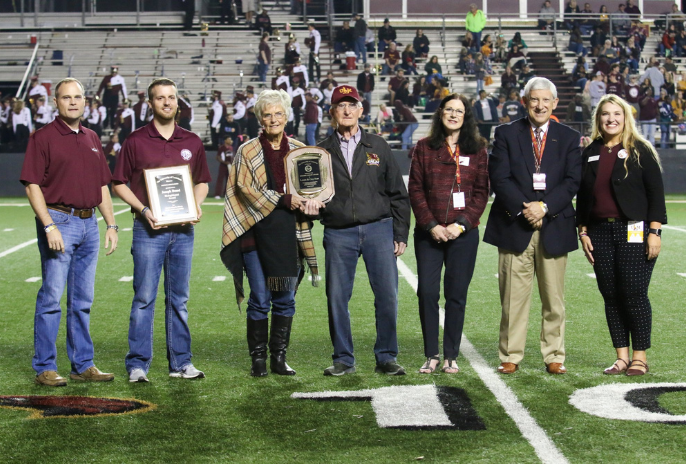 alumni award winners on field