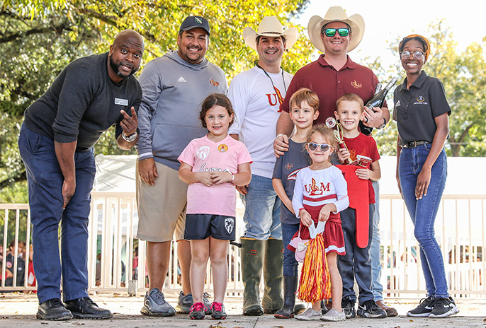 group shot of smiling alumni tailgaters