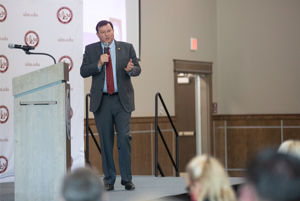 President Berry on stage with microphone