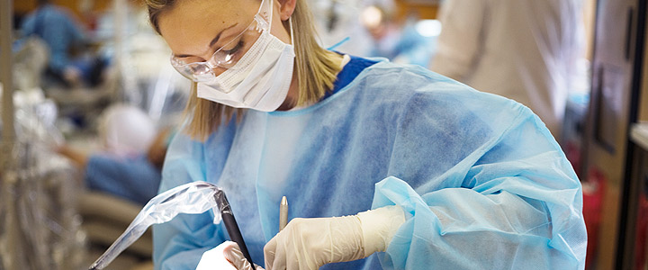 dental hygiene student working on patient