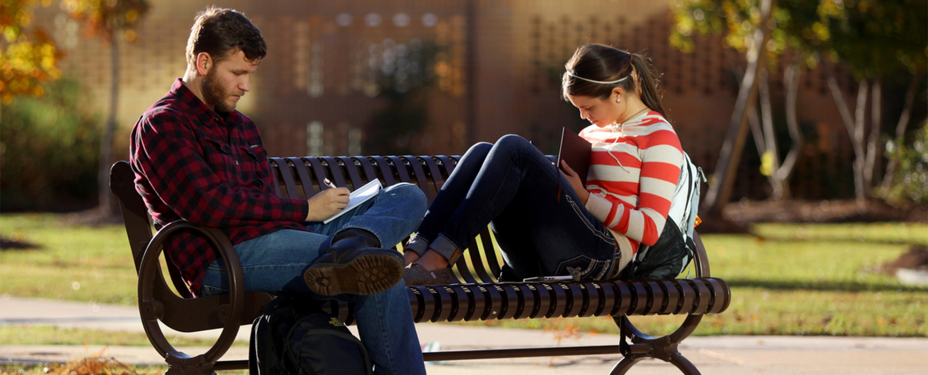 #slide1 students on park bench studying