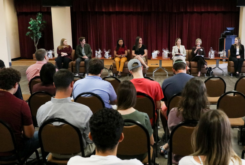 photo of students and professionals in a forum