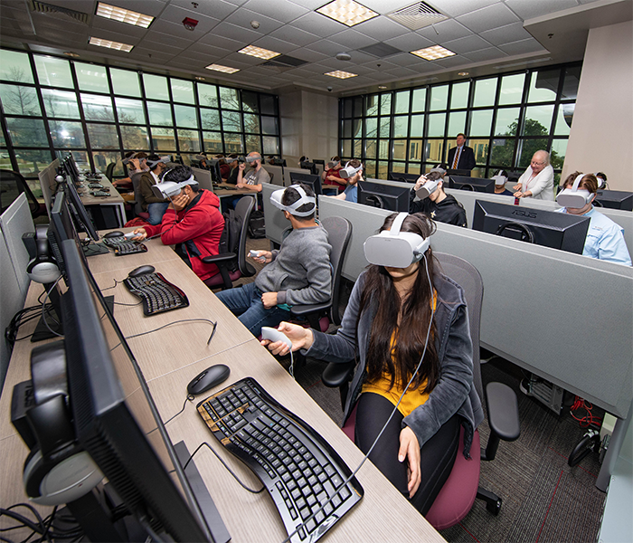 photo of students in classroom wearing headsets