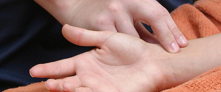 close-up of hands checking pulse
