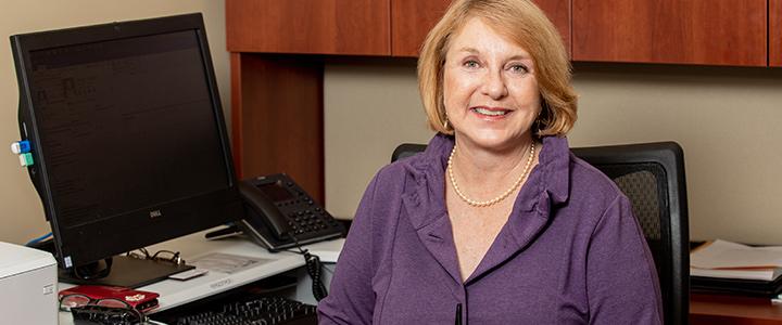 Dr. Susan Lacey seated at desk