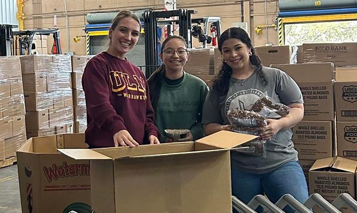 APhA students volunteer at the Northeast Louisiana Food Bank. Help is provided by packing boxes of canned goods and other grocery supplies to then be shipped out to the community.