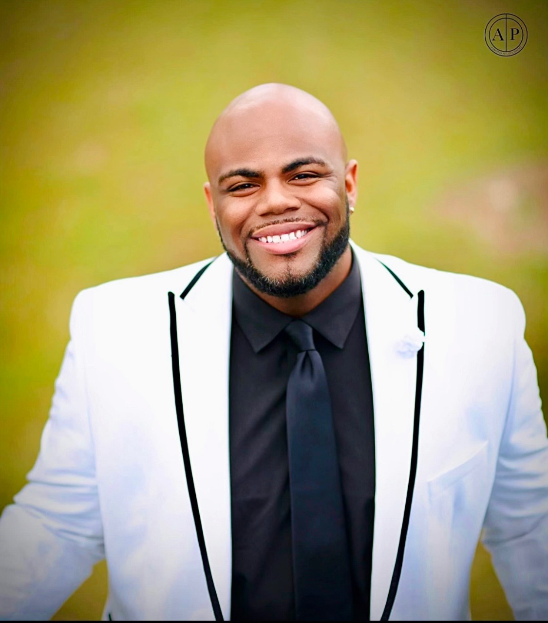 Adrian Adams Adrian Adams wearning a white jacket and black shirt with a black tie.