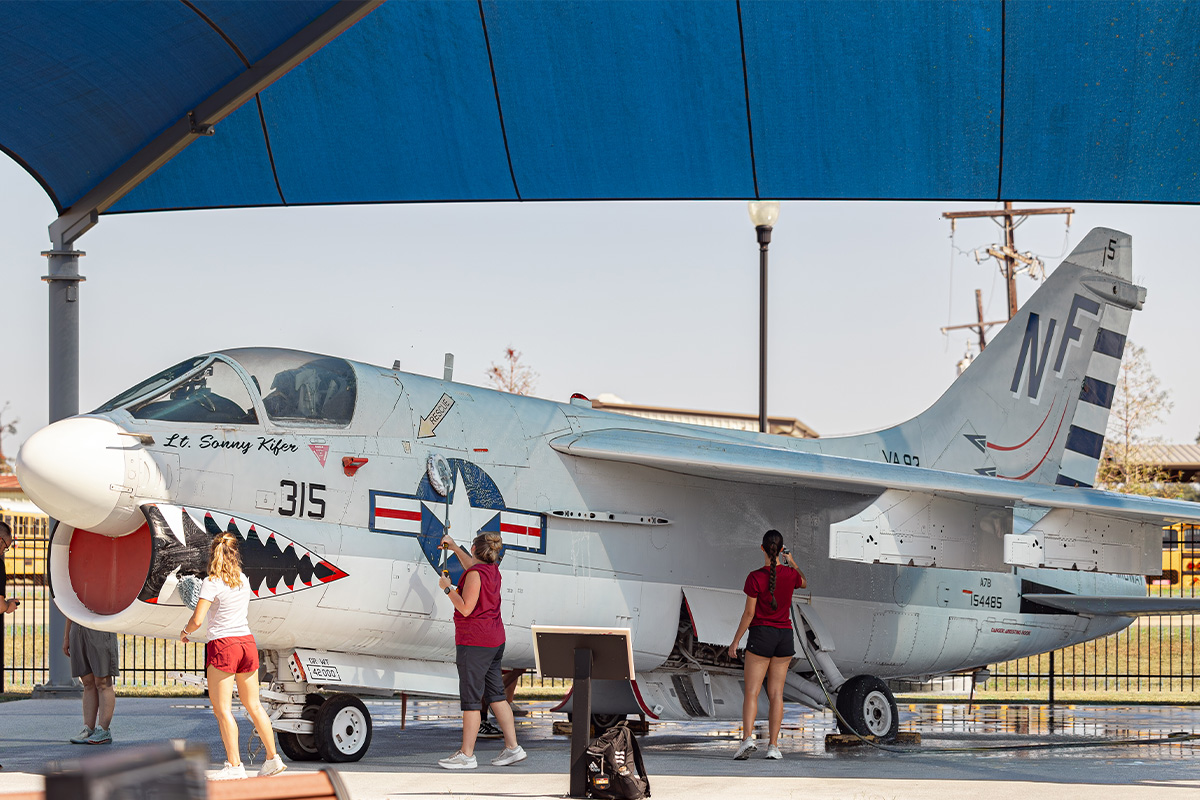 ULM student volunteers wash a plane at Chennault Aviation and Military Museum as part of Operation Warhawk Service for 9/11 Day on September 9, 2026.