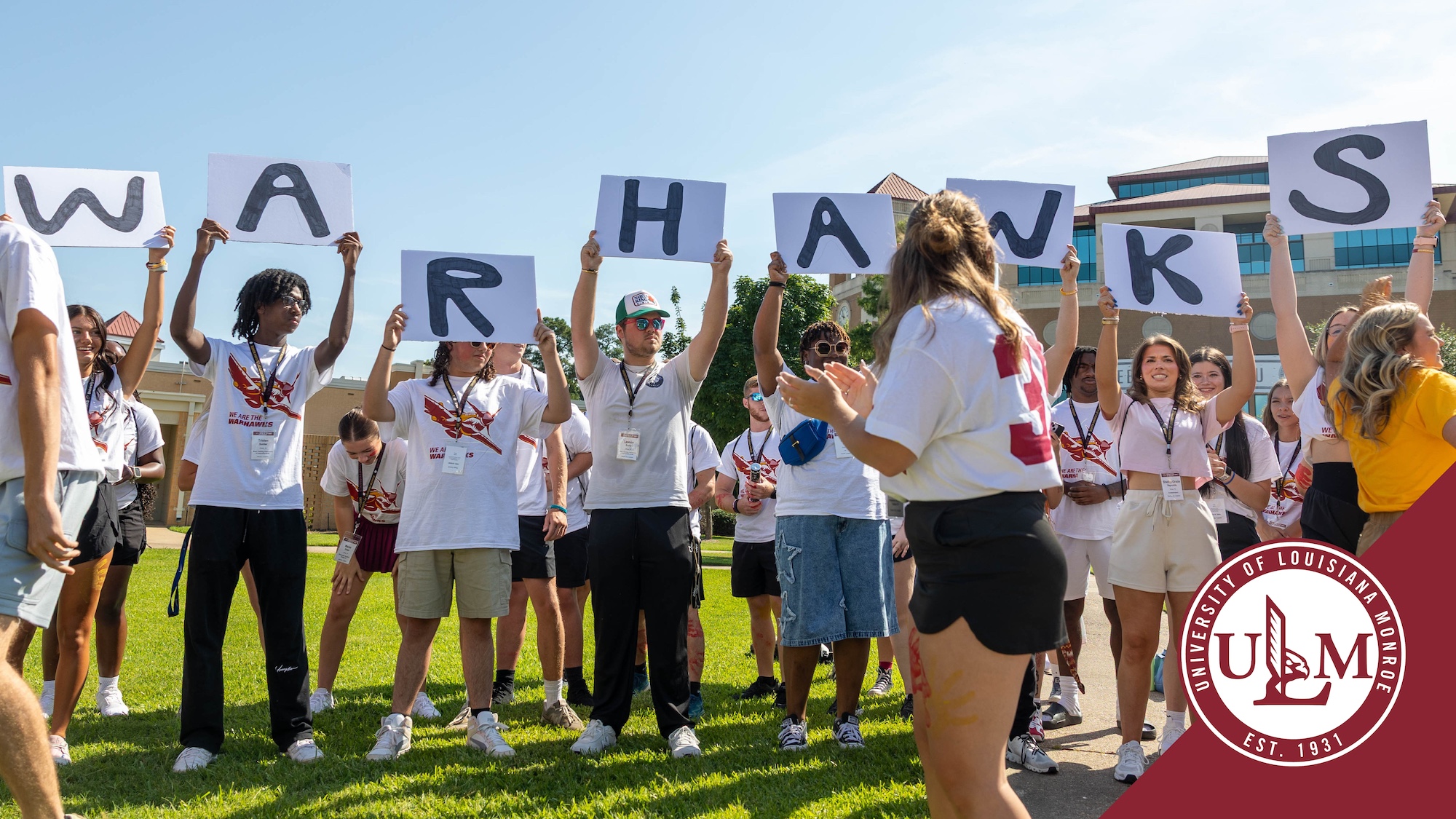 A group of freshmen hold up a sign that reads "Warhawks" during a PREP spirit day.