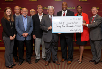 photo of President Bruno and Guests holding check