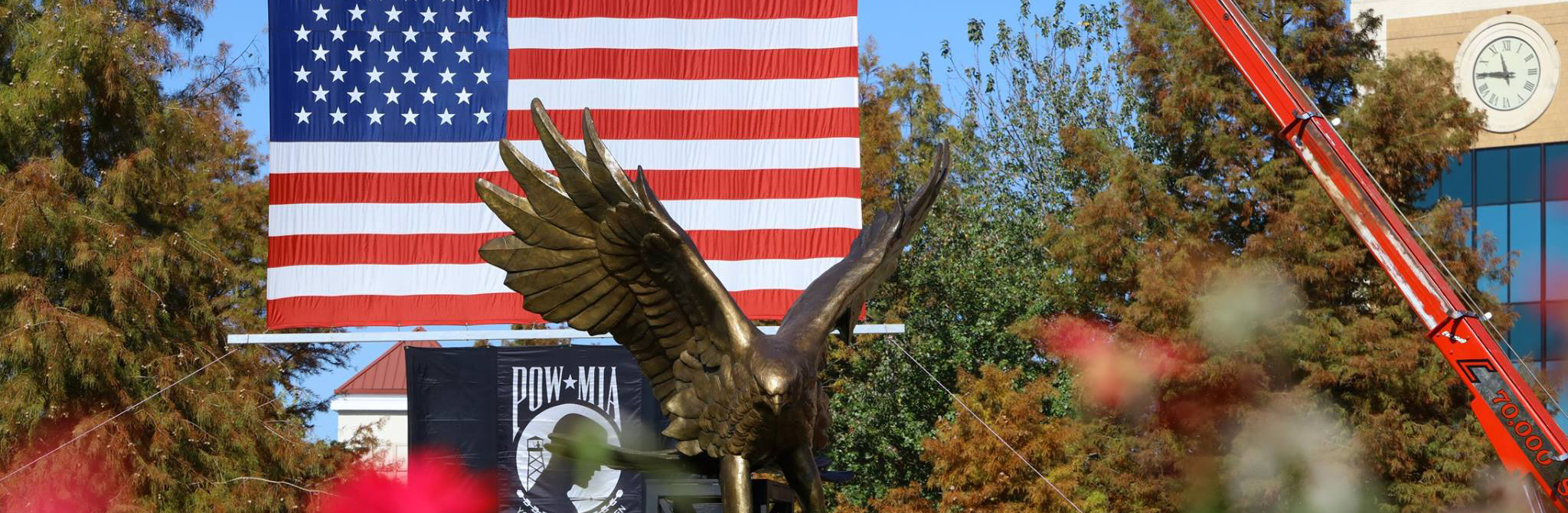 warhawk statue with flag behind