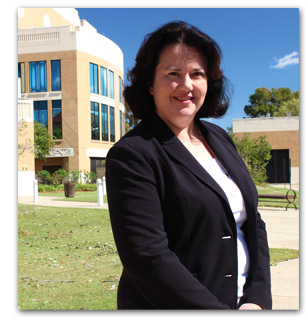 photo of Karen smiling in front of ULM library