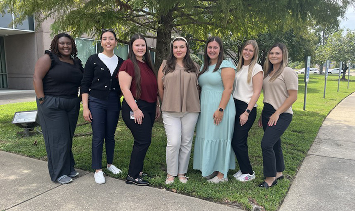 ULM COP LSHP's seven officers for 2025 in front of the ULM College of Pharmacy building.