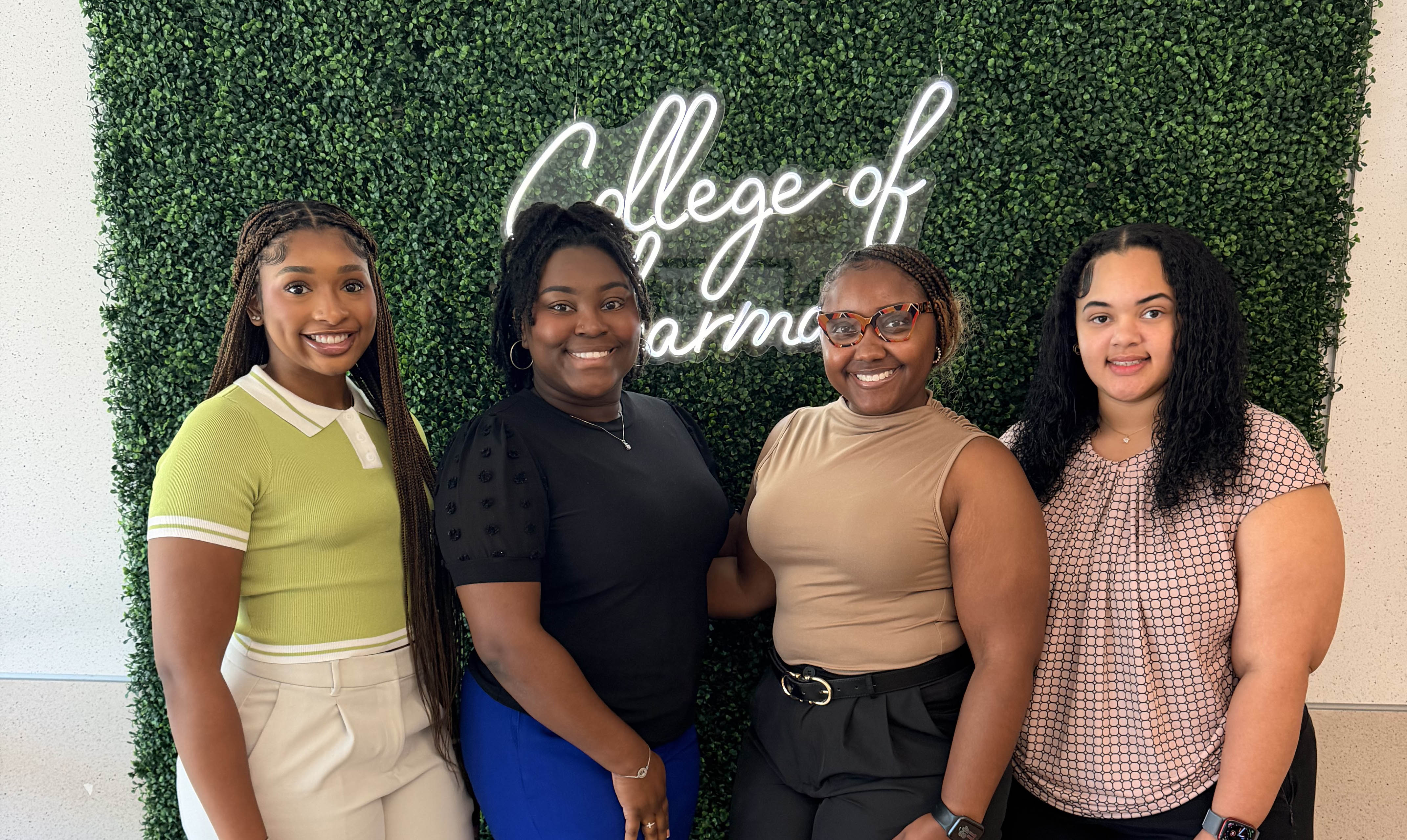 Four female COP students in front of a greenery board. R.O.A.D.S. Executive Board