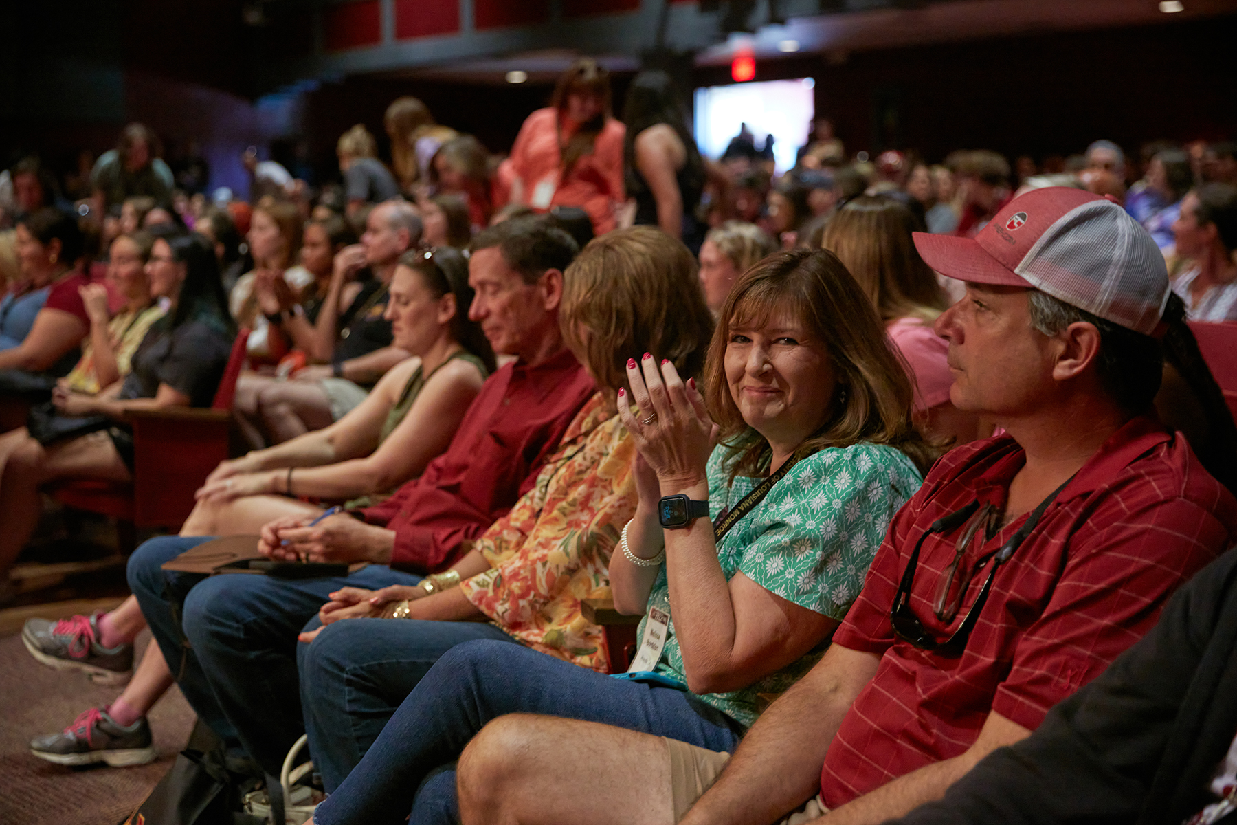 People sit in a theatre. 