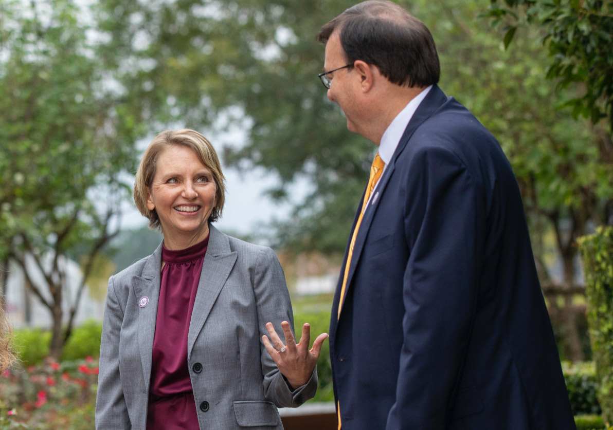 Dr. Christine Berry and the President walking on campus