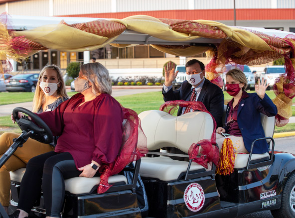 president in golf cart in parade